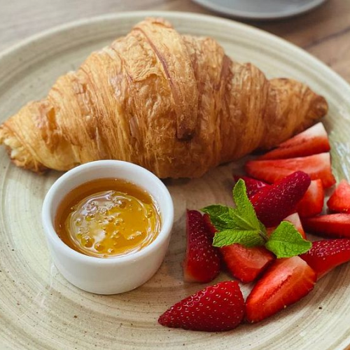 Croissant with fresh berries and honey